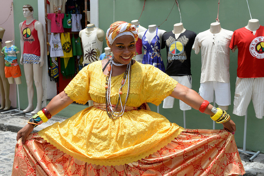 Brazilian woman wearing traditional clothes of the Bahia region in Salvador da Bahia, the city of the Holy Saviour of the Bay of all Saints on the northeast coast of Brazil , South America