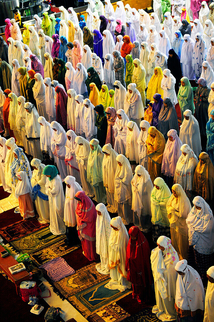 Women praying inside Istiqlal Mosque or Masjid Istiqlal , the biggest mosque of South East Asia ,in Jakarta, Java island, Indonesia, South East Asia