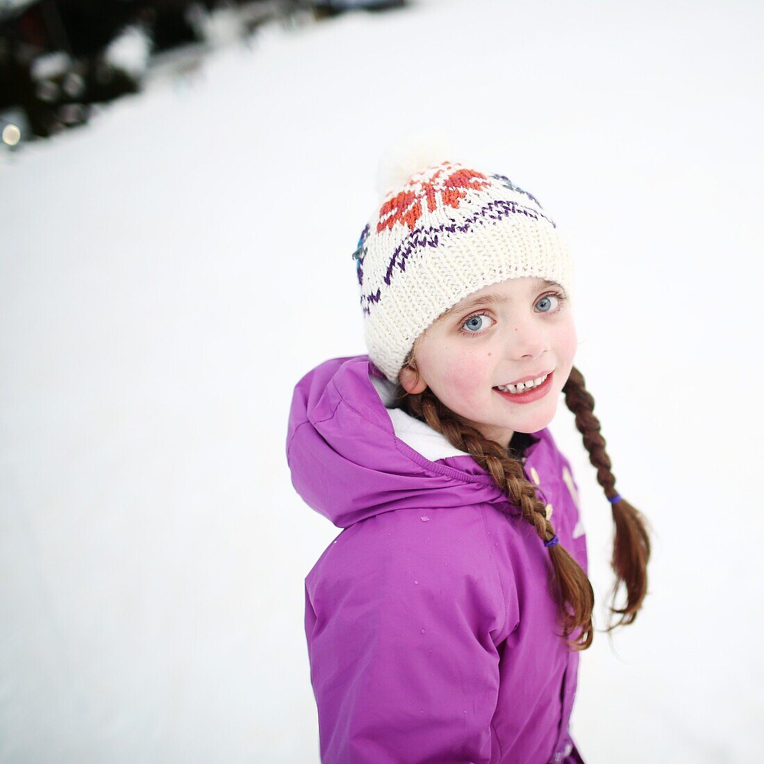 Portrait of a 5 years old little girl in the mountains, in winter