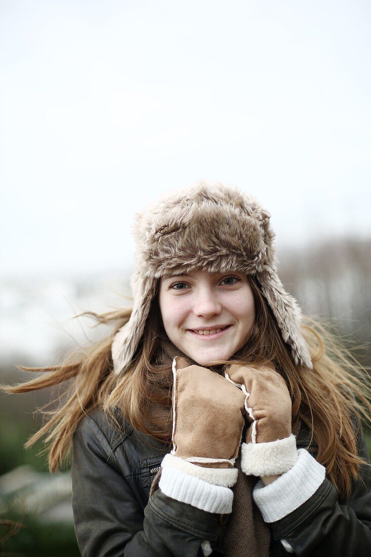Portrait of a teenage girl wearing a fur hat