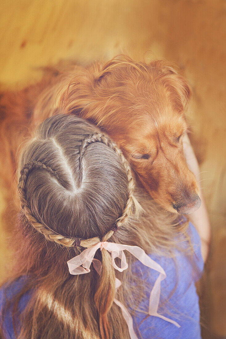 Caucasian girl hugging dog