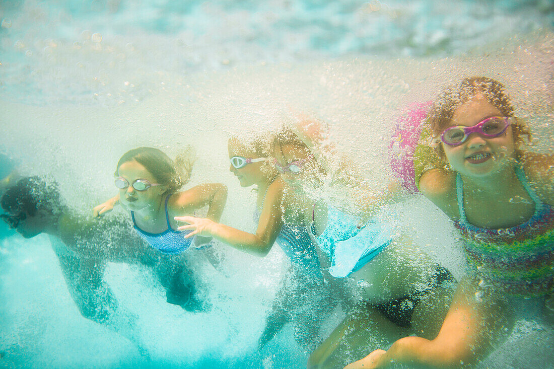 Children underwater in swimming pool