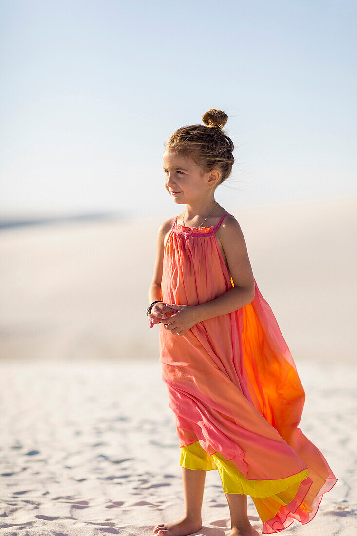 Girl standing on desert sand dune