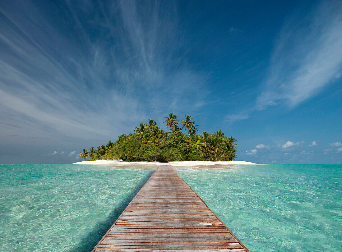 Wooden dock walkway to tropical island