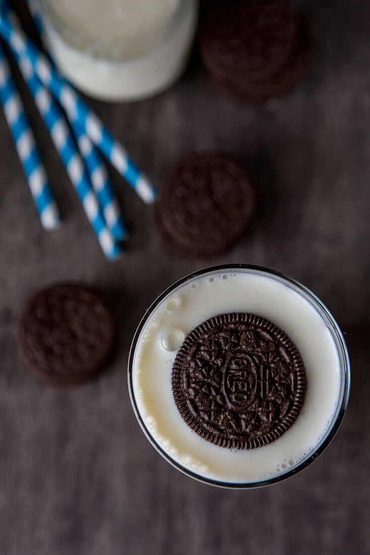 Oreo Cookie Floating in Glass of Milk, High Angle View