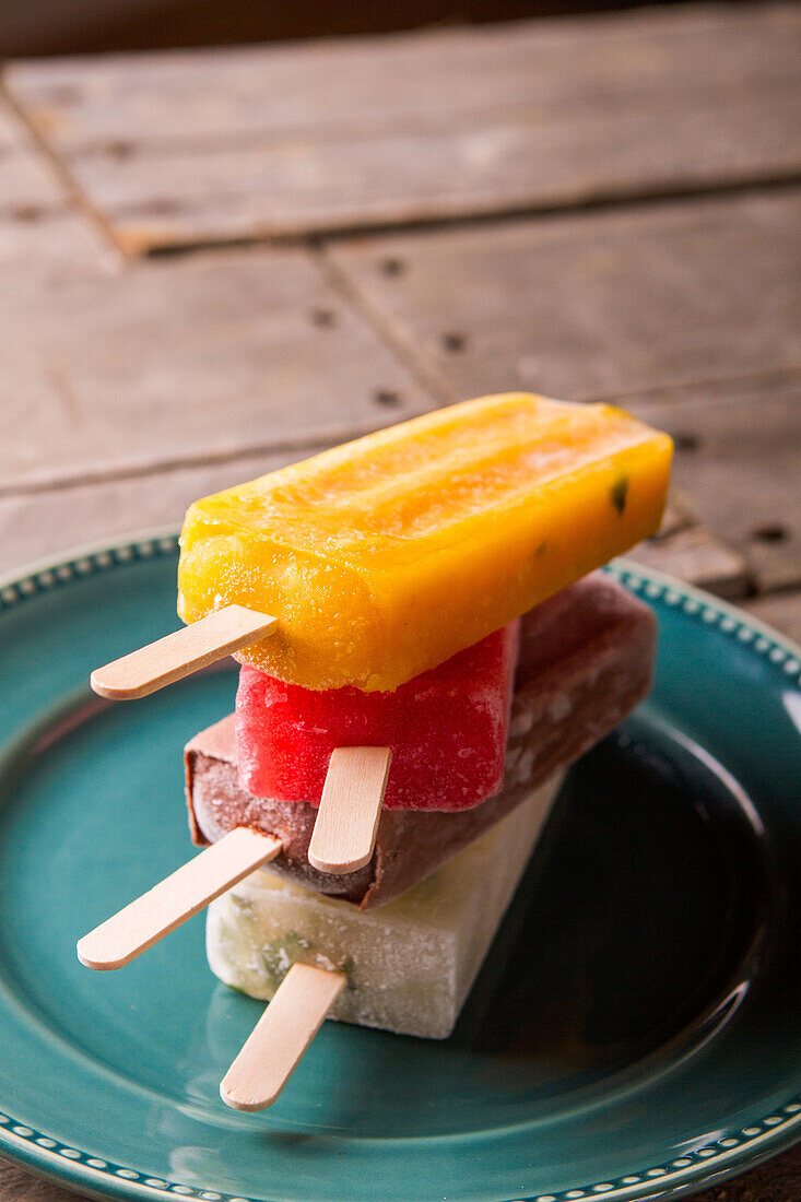 Four Ice Popsicles on Plate