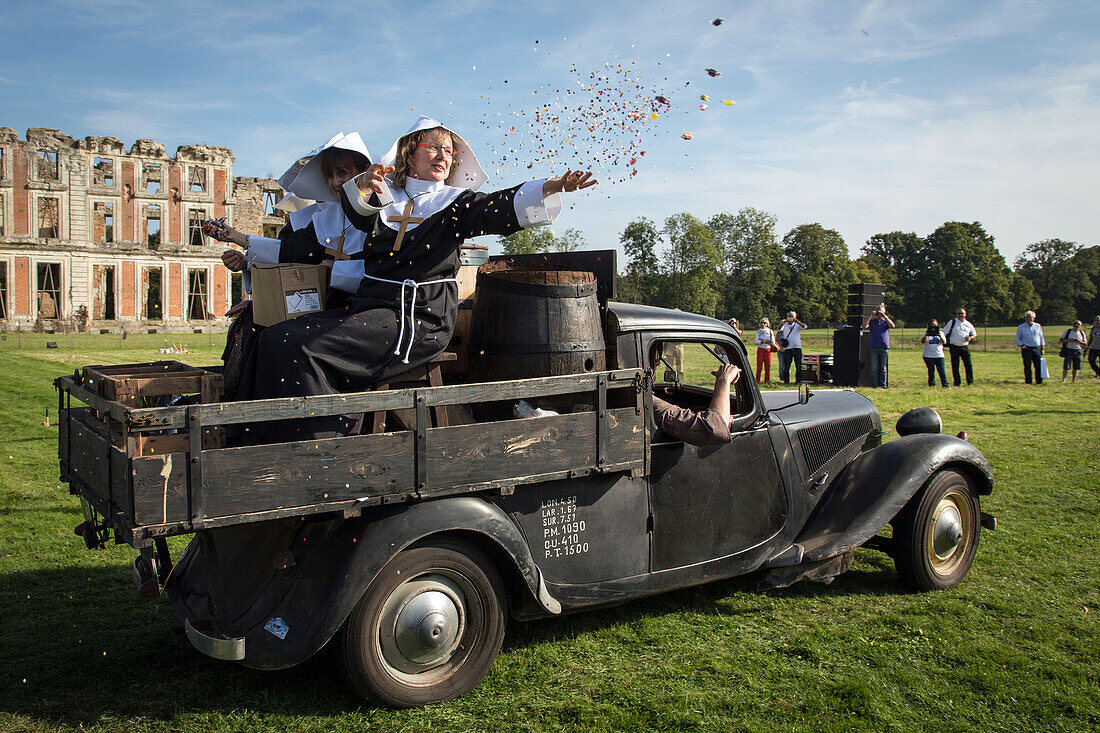 nuns distributing candy for the 80 years of the front-wheel drive 'traction avant', legendary car in the park of the chateau saint-simon, la ferte-vidame, eure-et-loir (28), france