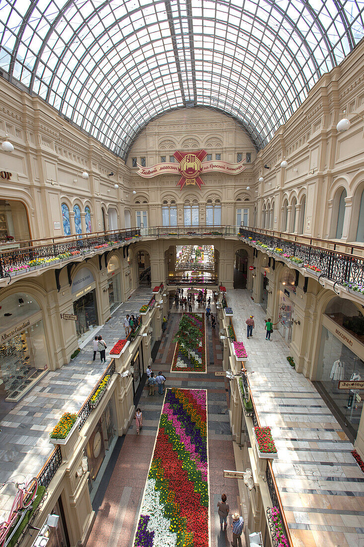 interior of the gum department store, big glass ceiling, two-level mezzanine, interior design by jean michel wilmotte, red square, moscow, russia