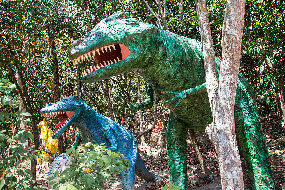 dinosaurs at the entrance to the representation of hell, wat keaw prasert, pathio, province of chumphon, thailand, asia