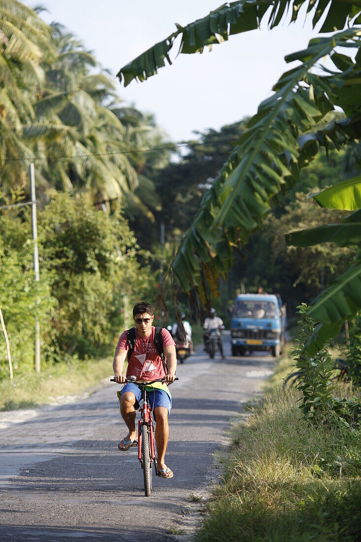 Tourist on main street of the island, connecting resorts on the east coast, near Beach No.3, Havelock Island, Andaman Islands, Union Territory, India