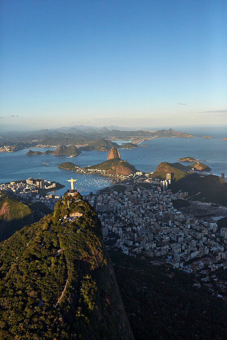 Cristo Redentor (Christ the Redeemer) statue on Corcovado Mountain, Tijuca Forest in the southern part of town, facing east over Baia de Guanabara, Sugar Loaf Mountain, helicopter tour, Rio de Janeiro, Brazil