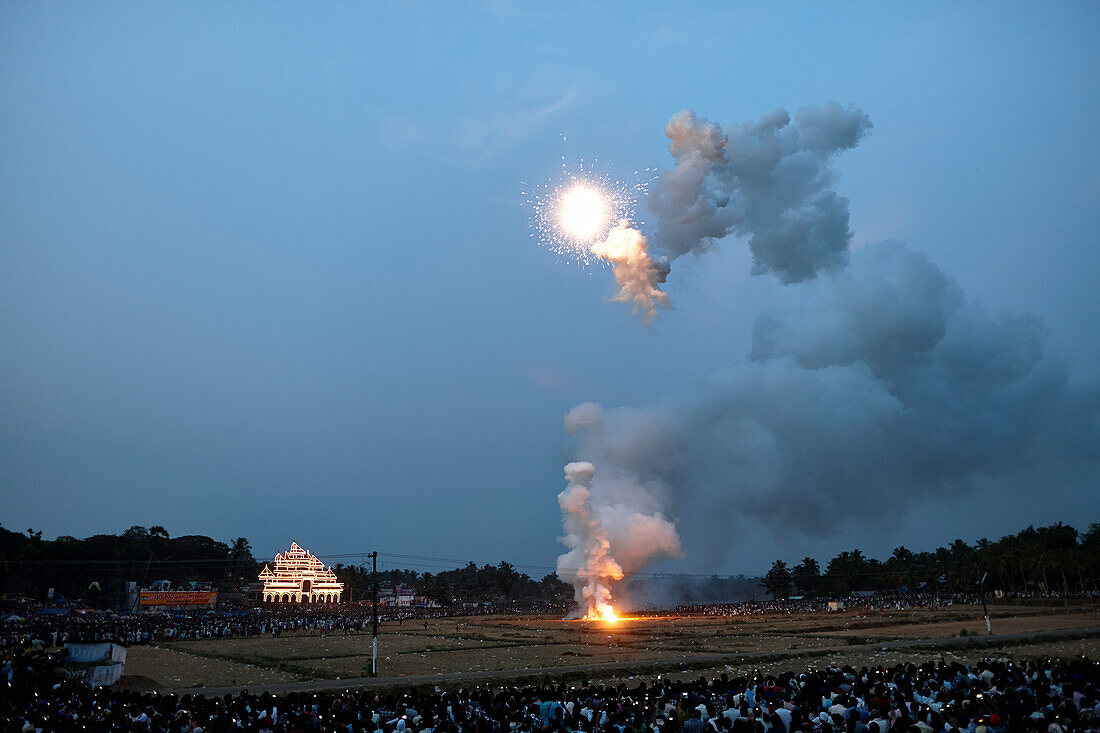 Deafening fireworks, harvested rice fields, hundreds of thousands of visitors around it, illuminated timber scaffolding Aana Pandal in the back, Nemmara Vela, Vela Festival takes place in summer after harvest, Hindu temple festival in the village Nemmara 