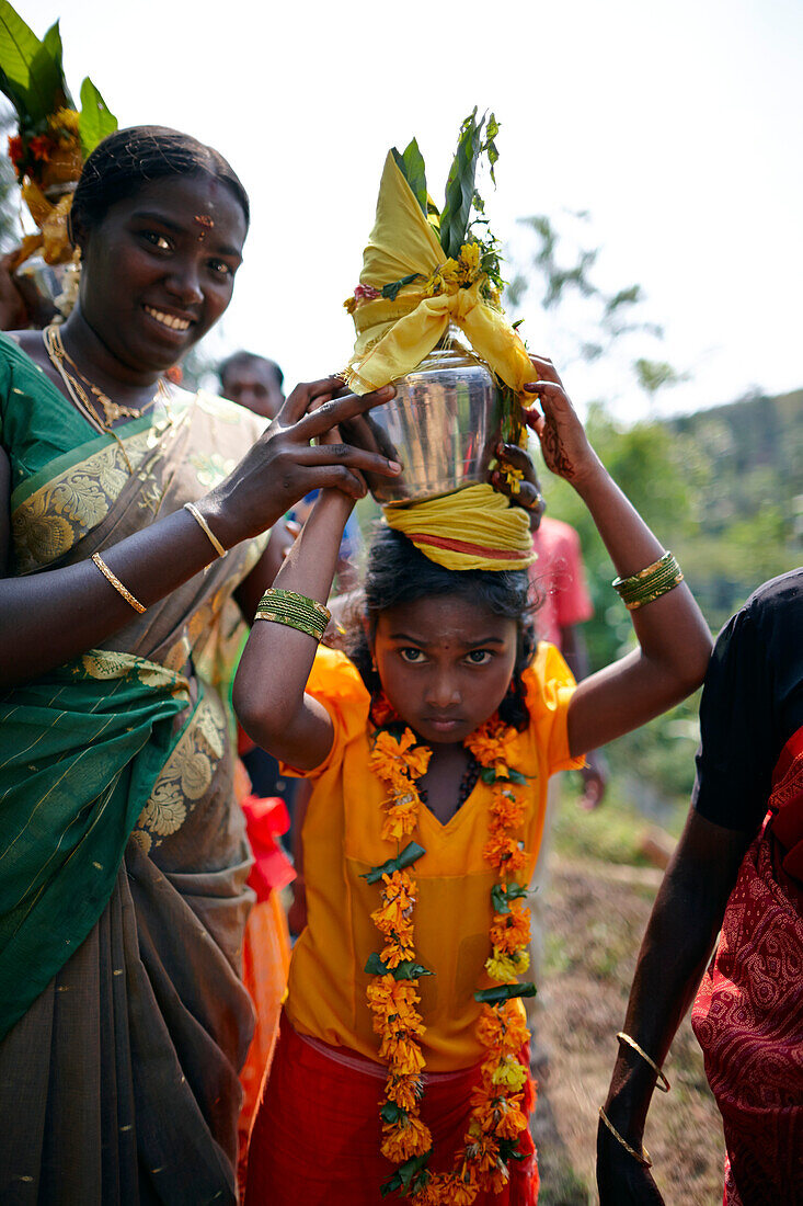 Girl carrying holy water to the temple, Sri Vinayagar temple festival, annual Hindu festival in the village of Nadukahni, northwest of the Nilgiri Hills (Ooty), Western Ghats, Tamil Nadu, India