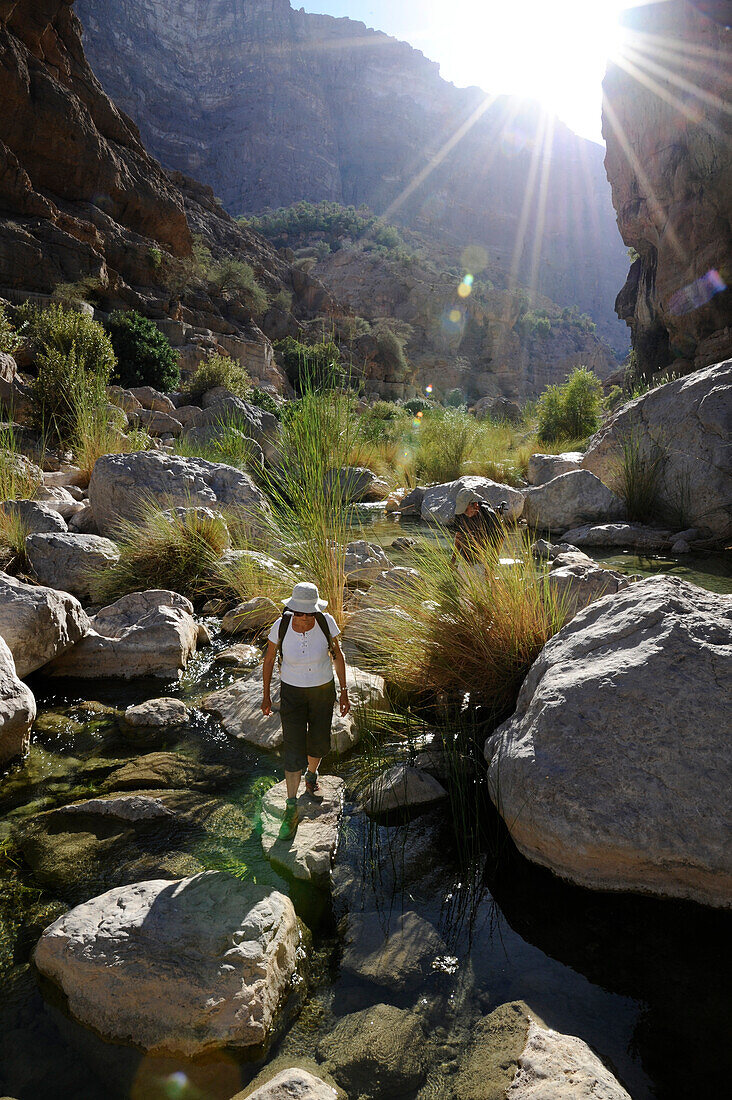 Sultanate of OMAN,Sharqiyah area, a tourist is hiking in the middle of the rocks' chaos of the wadi Tiwi
