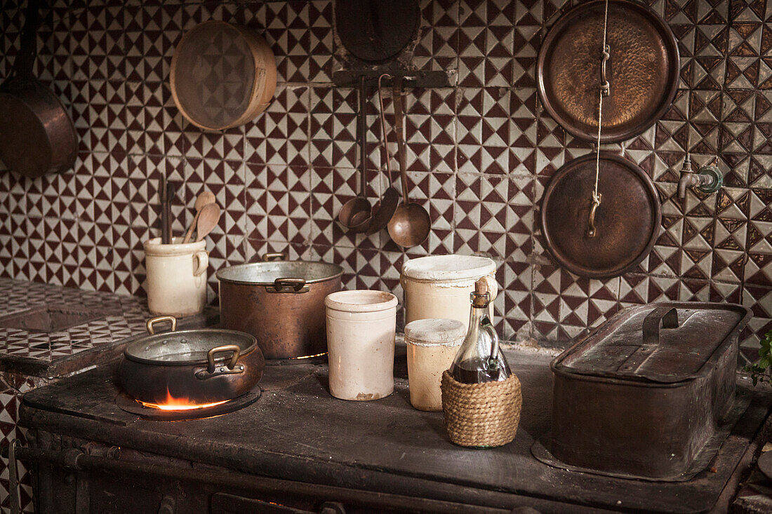 Pots and pans on cast iron stove in kitchen