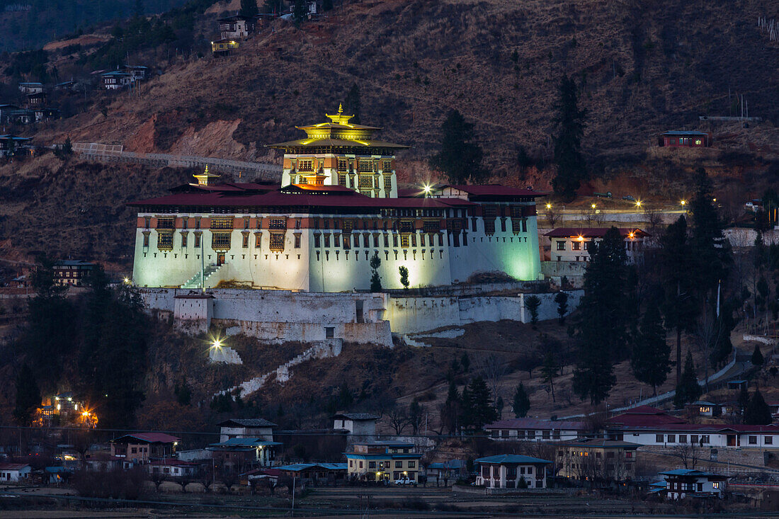 Illuminated buildings on rocky remote hillside, Paro, Western Bhutan, Bhutan