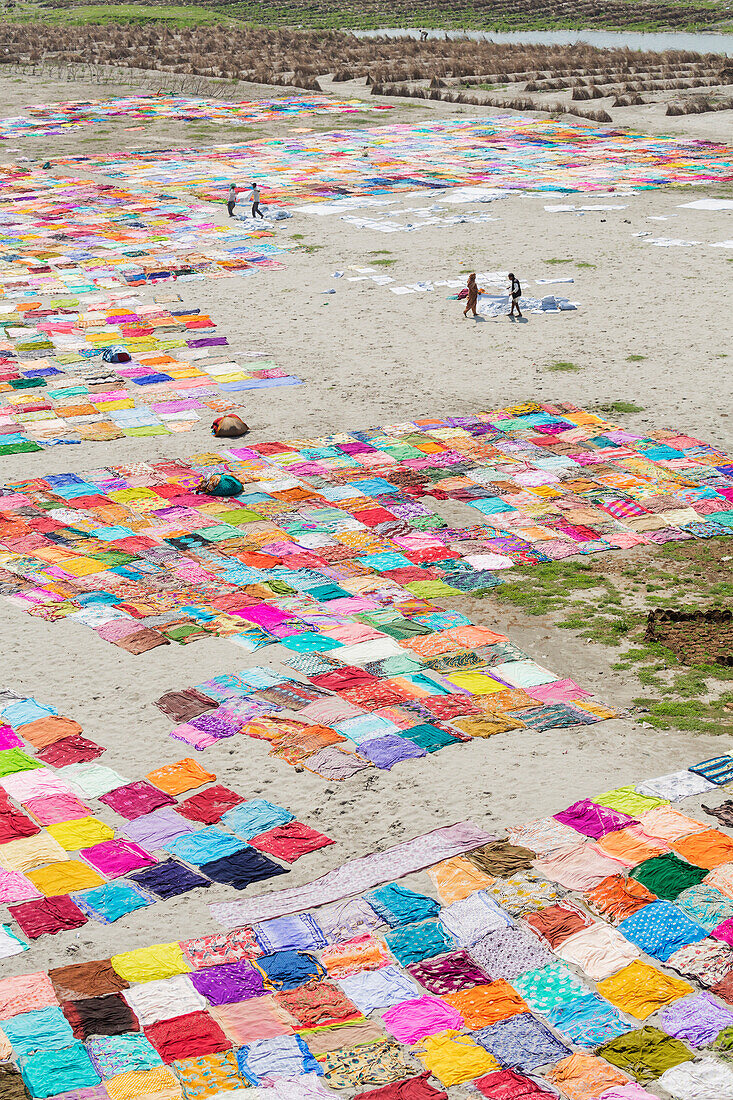 High angle view of colorful saris drying on riverbank