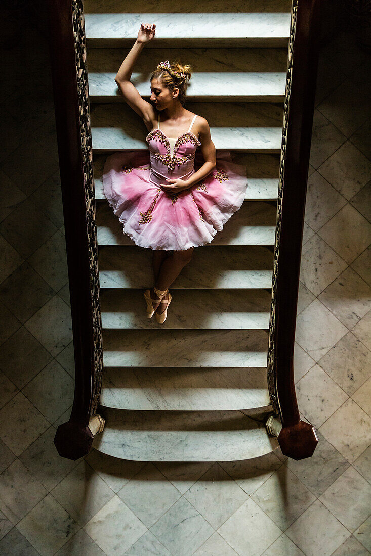 Hispanic ballet dancer posing on staircase