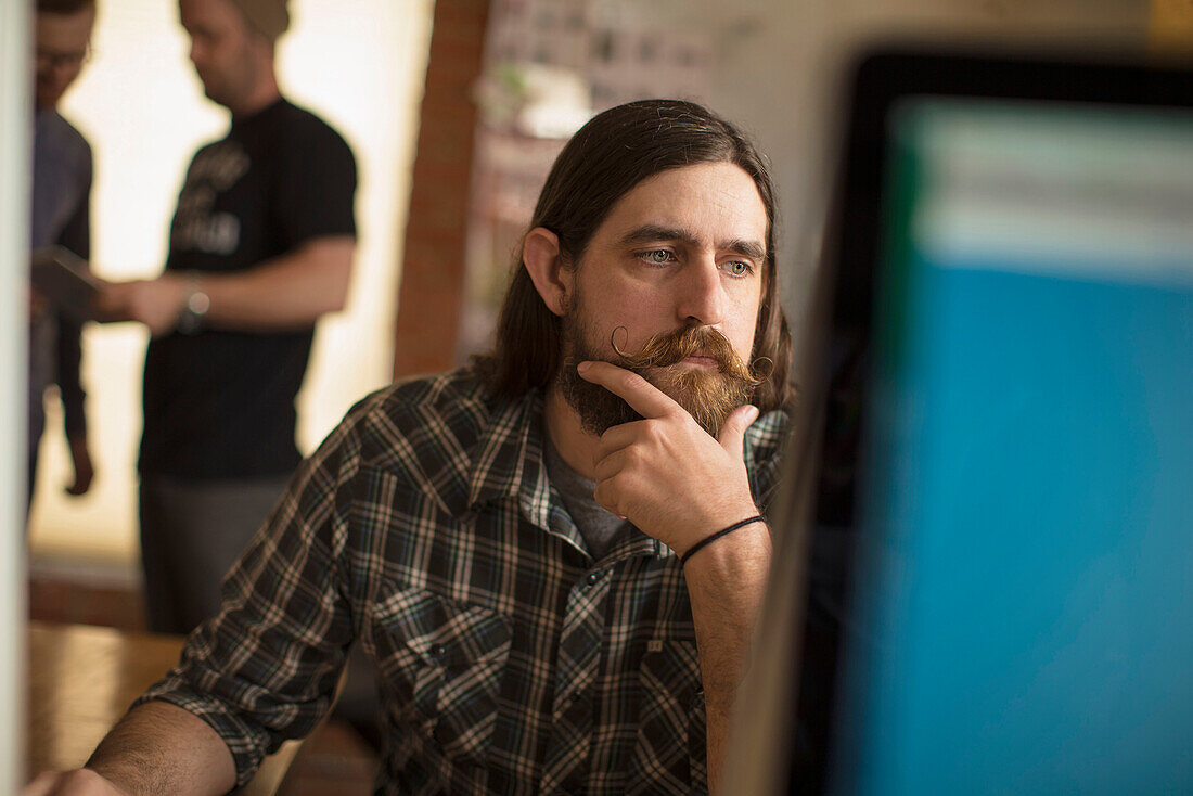 Serious businessman working at computer in office