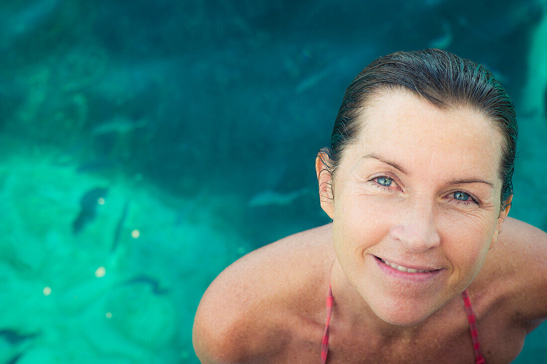 Caucasian woman smiling in swimming pool