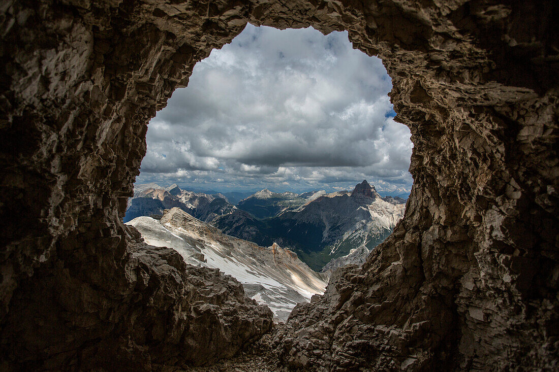 Remote mountain landscape viewed through rock formation