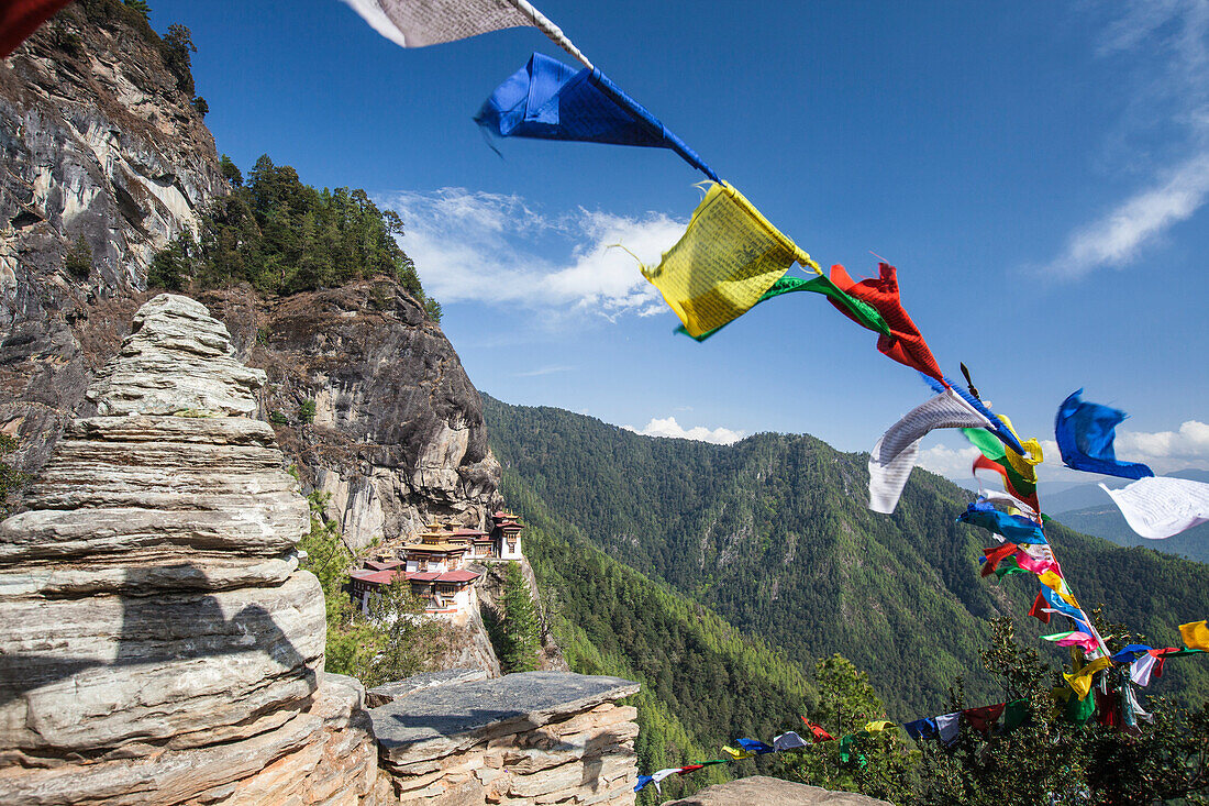 The colorful Tibetan prayer flags invite the faithful to visit the Taktsang Monastery, Paro, Bhutan, Asia