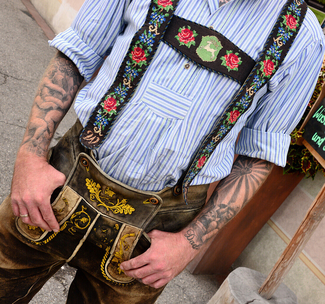 Man with tattoo in leather trousers, Lenggries, Bavaria, Germany