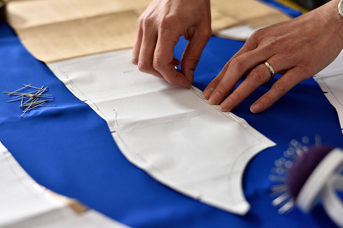 Woman preparing material, dressmaking in Hamburg, Germany