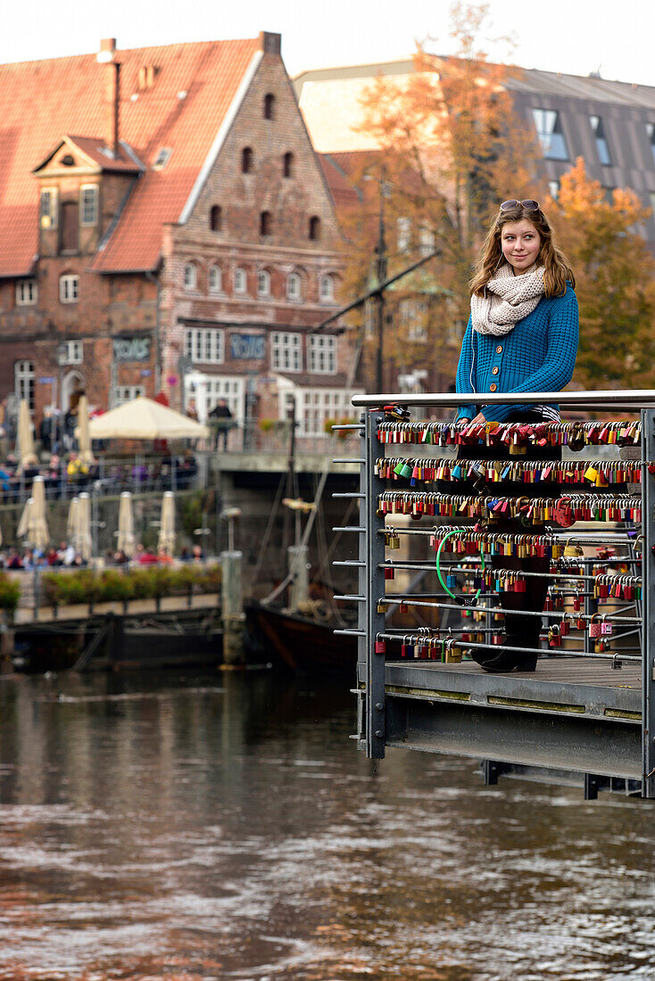 Mädchen auf Brücke mit Liebessschlössern, Lüneburg, Niedersachsen, Deutschland, Europa