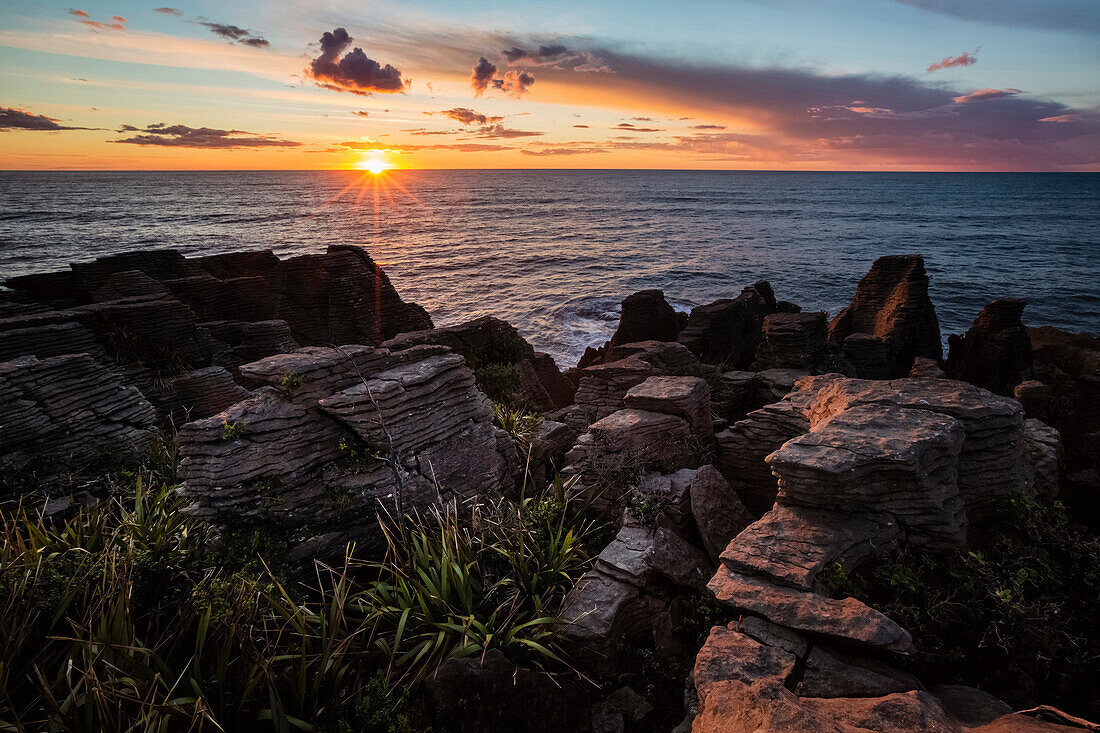 Sunset over rocky coastline and ocean