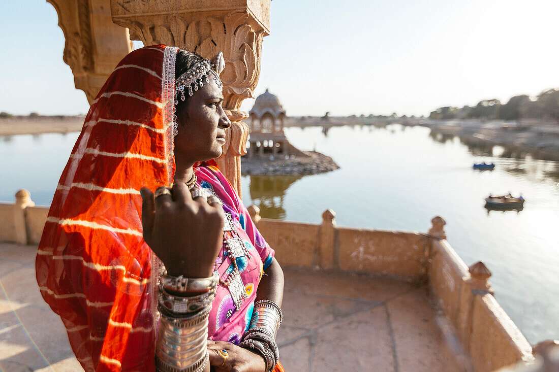 Indian woman admiring view from monument, Jaisalmer, Rajasthan, India