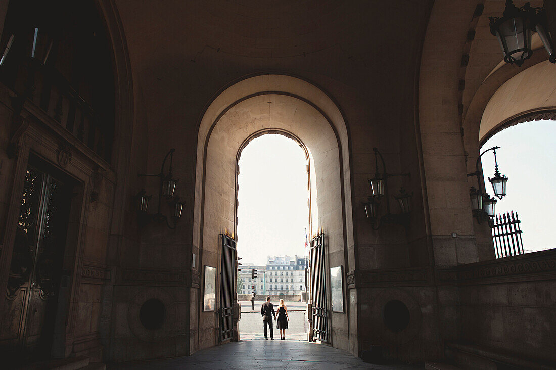 Caucasian couple standing in church archway