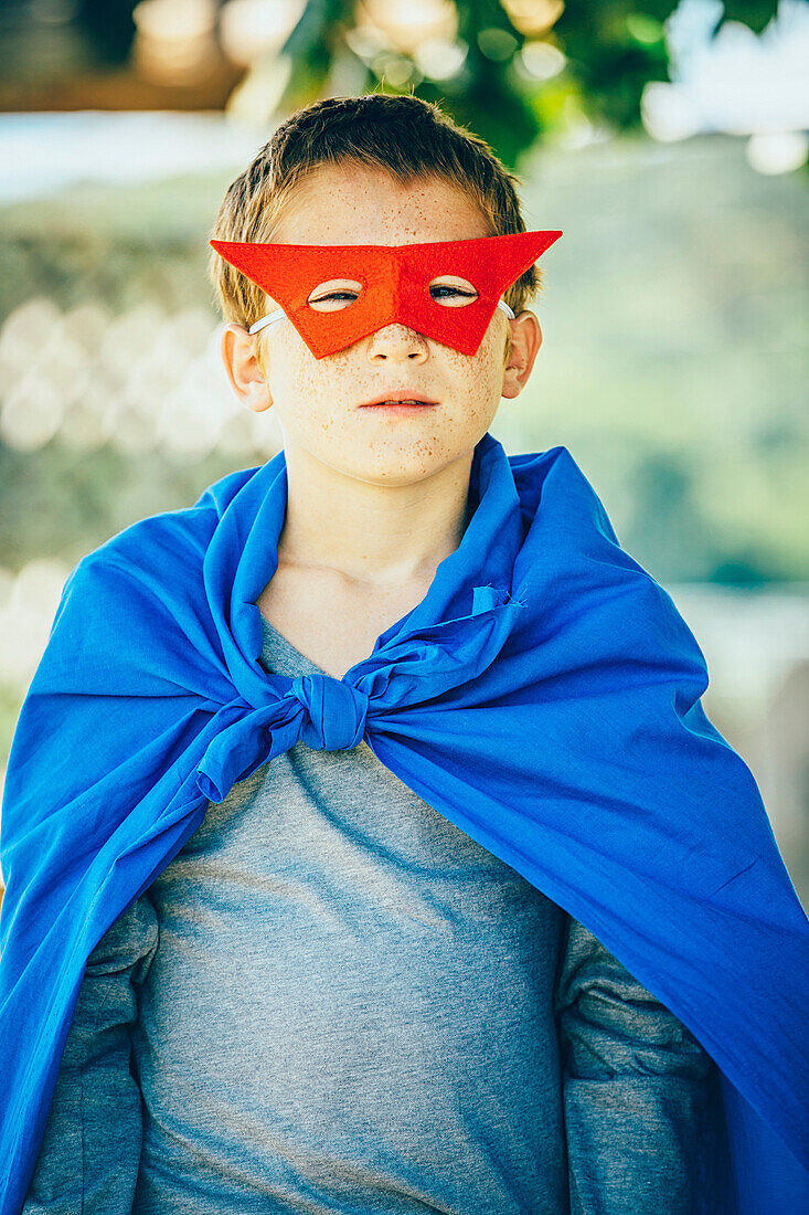 Caucasian boy wearing superhero costume