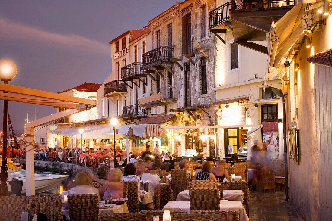 Time lapse view of sidewalk cafe at sunset, Mykonos, Cyclades, Greece