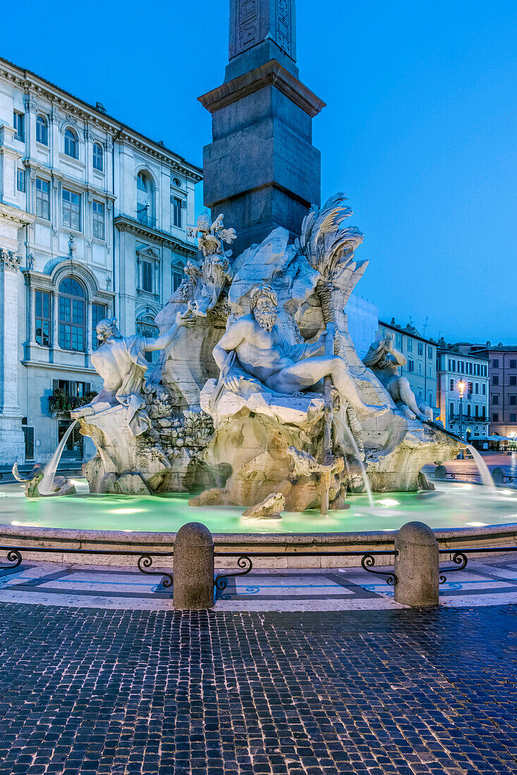 Four Rivers Fountain illuminated at night, Rome, Italy