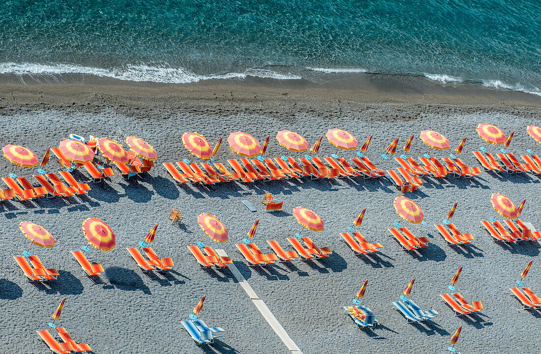 Aerial view of lawn chairs and umbrellas on beach