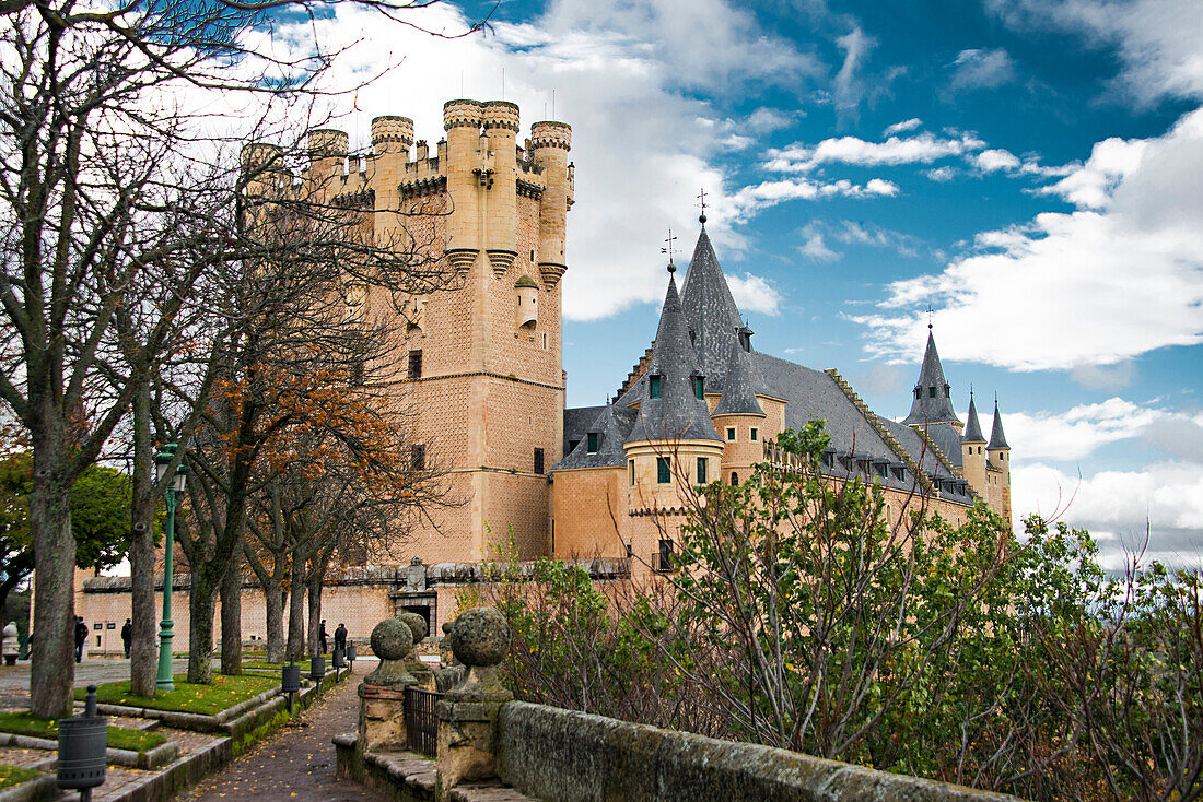 Ornate castle tower and spires with courtyard, Segovia, Spain