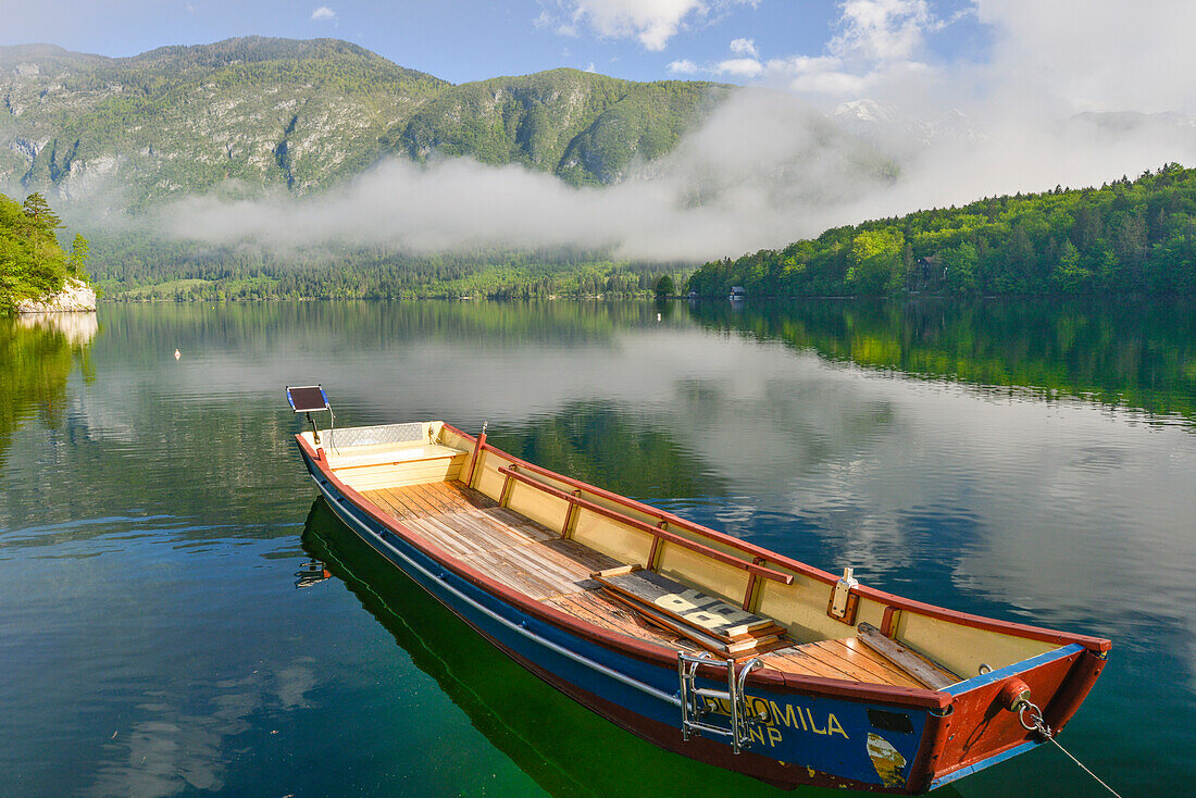boat and reflection at Lake Bohinj, with mountains and wood in the background, Ribcev village, Stara Fuzina, Bohinj, Gorenjska, Julian Alps, Triglav National Park, Slovenia, Europe