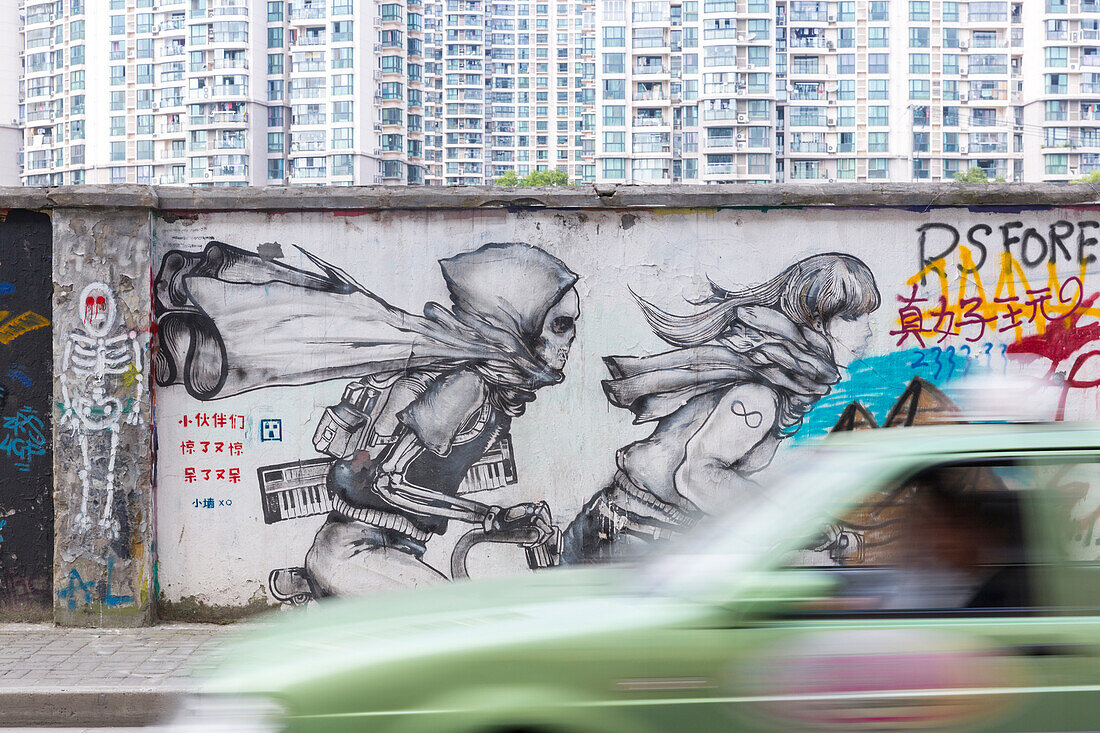 Funny graffiti on wall on Moganshan Road, car passing, street art, Art district at Wusong River, Putuo District, Shanghai, China, Asia