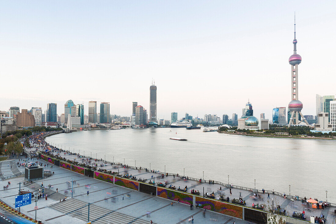Evening on the Bund, tourists, skyline of Shanghai, dusk, twilight, Oriental Pearl Tower, boats on Huangpu River, Pudong, Shanghai, China, Asia
