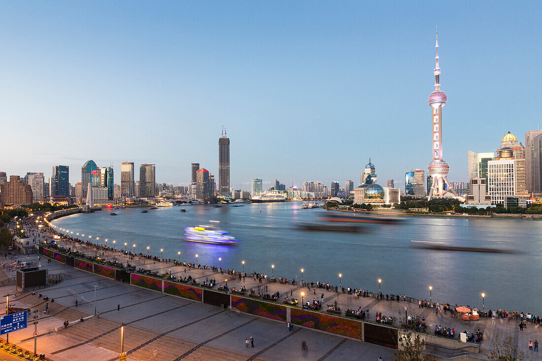 Evening on the Bund, tourists, skyline of Shanghai, dusk, twilight, Oriental Pearl Tower, boats on Huangpu River, Pudong, Shanghai, China, Asia