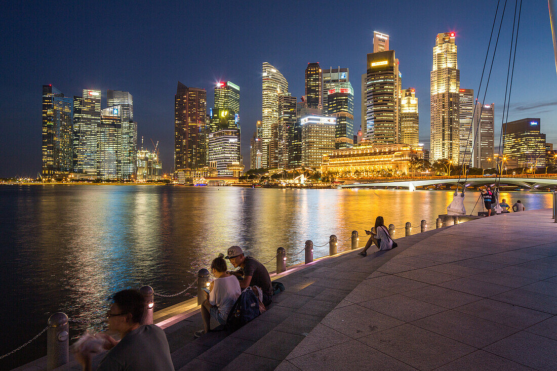 evening, Marina Bay, waterfront, people sitting on stone steps, Singapore Skyline and historic Fullarton Hotel, city, business, high-rise, Singapore, Asia