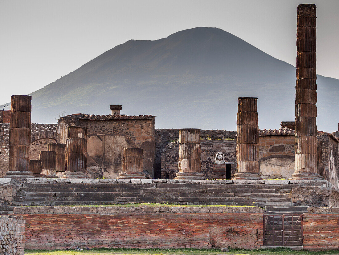 The Temple of Jupiter and Mount Vesuvius in the background, near Naples, Pompeii, Campania, Italy