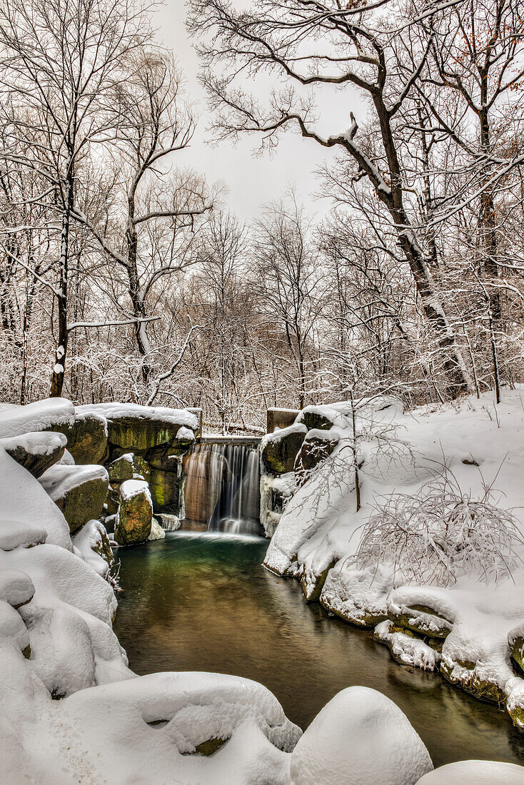 Snow-covered waterfall in The Loch, Central Park, New York City, New York, United States of America