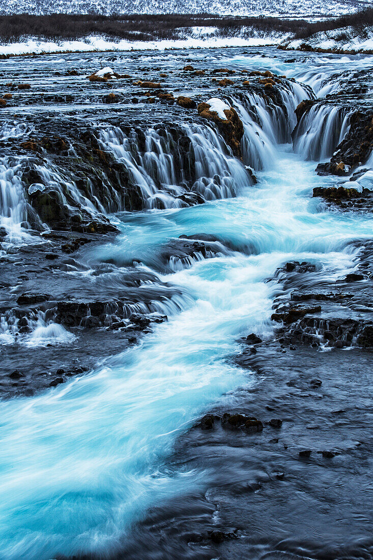 Turquoise water flowing over rocks into a river, Bruarfoss, Iceland