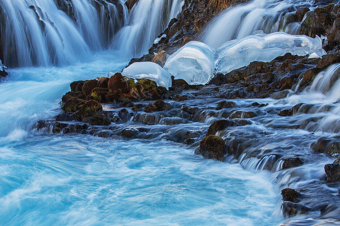 Ice lies at the foot of Bruarfoss, Iceland