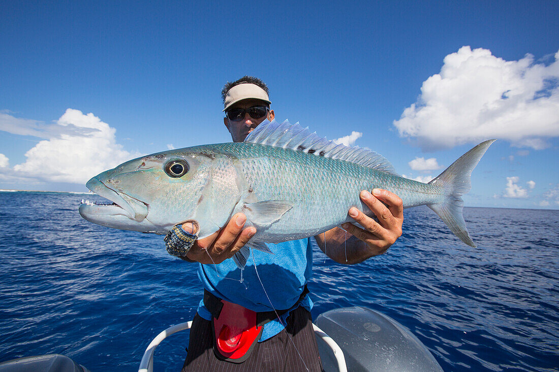 Fisherman holding fresh caught Jobfish, Tahiti