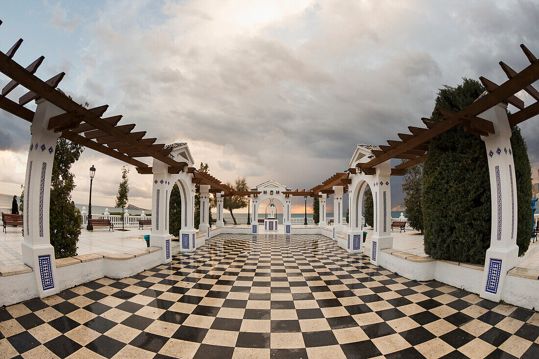 Black and white checkered tiles on a promenade along the mediterranean, Benidorm, Spain