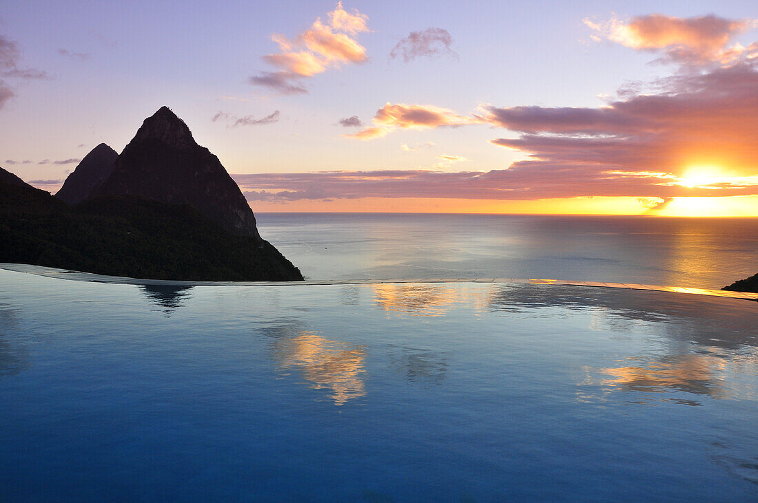 swimming pool of La Haut Plantation hotel at sunset with sea view and volcano mountains The Pitons with Gros and Petit Piton, UNESCO world heritage, Soufriere, St. Lucia, Saint Lucia, Lesser Antilles, West Indies, Windward Islands, Antilles, Caribbean, Ce
