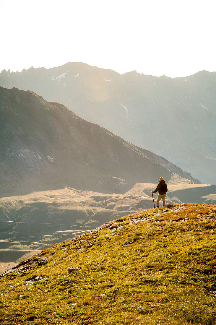 Mid-Adult Male Hiker Viewing Mountains Panorama at Sunset, Rear View, Col du Petit Mont Cenis, Val Cenis Vanoise, France